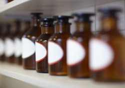 Row of drug bottles in pharmacy lab
